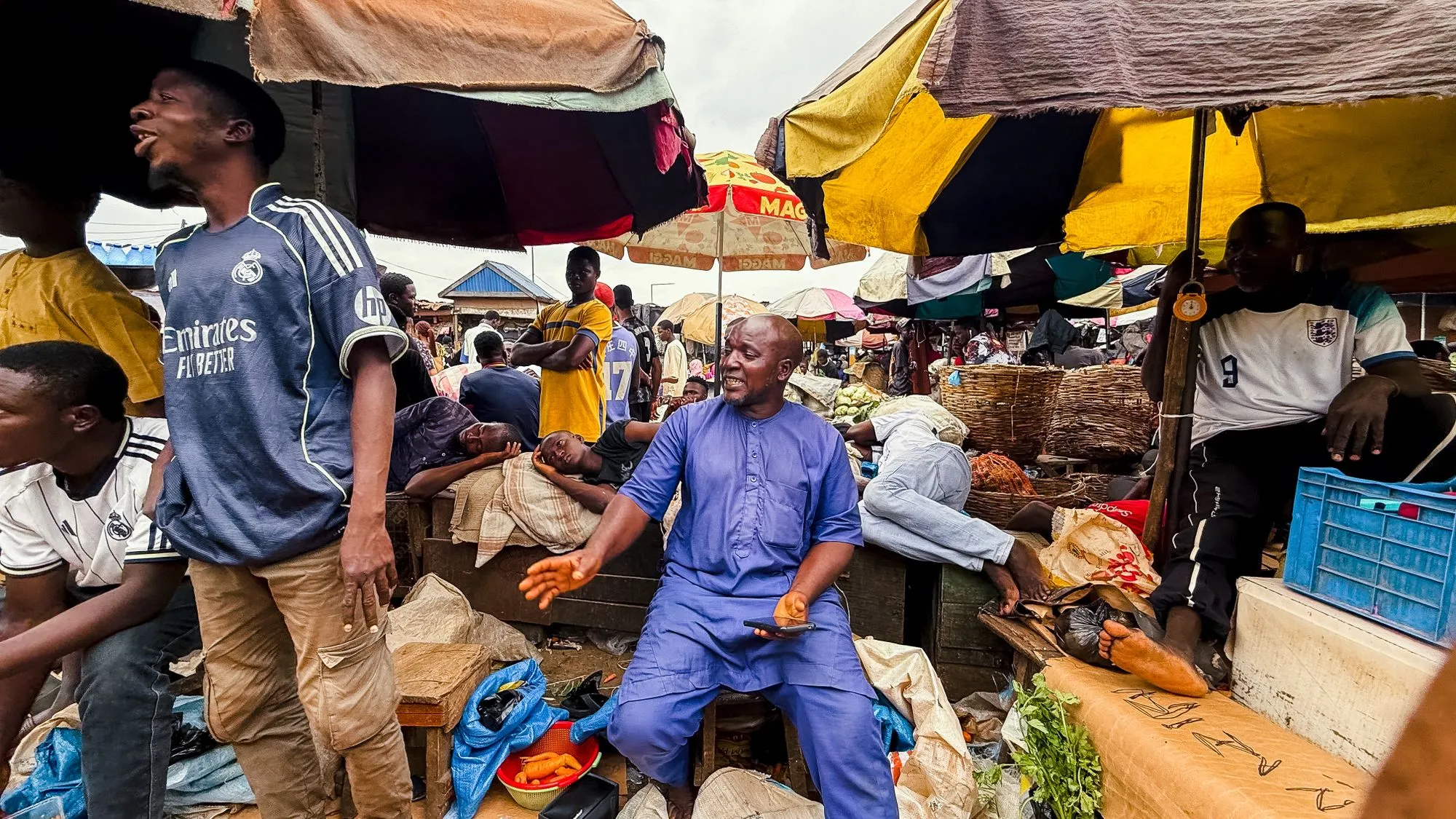 Traders and customers at a busy open-air market in Lagos, Nigeria